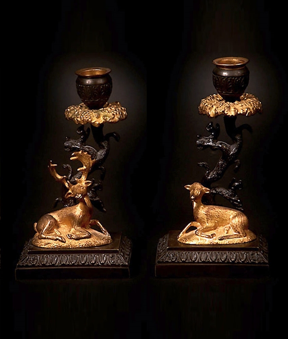 Picture of Regency pair of candlesticks of a stag and doe resting by stylised tree